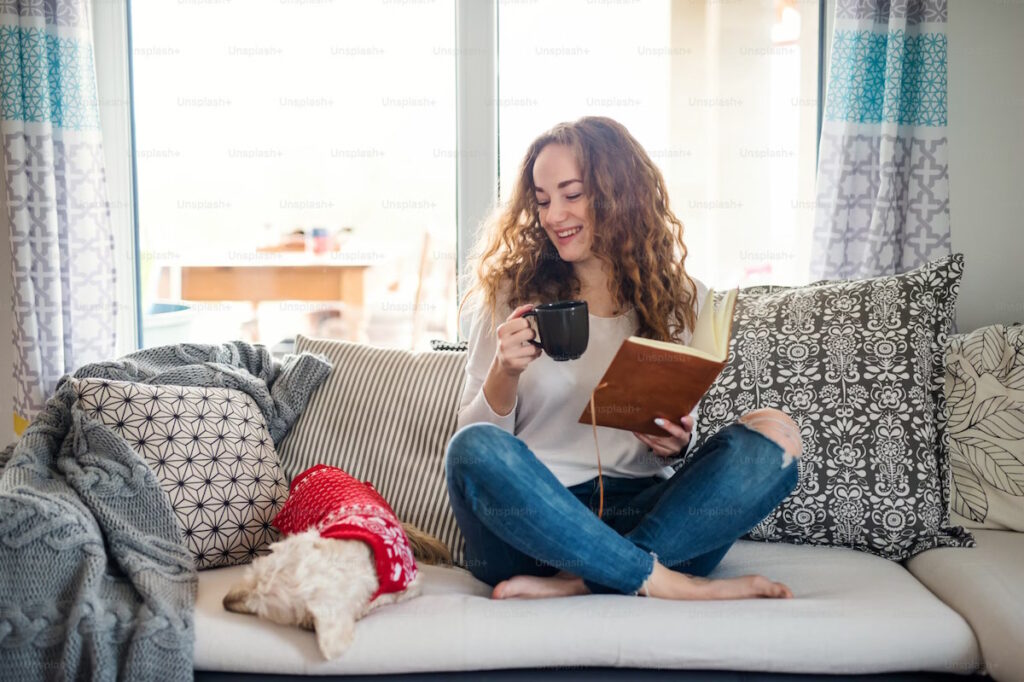 woman reading to sleeping dog
